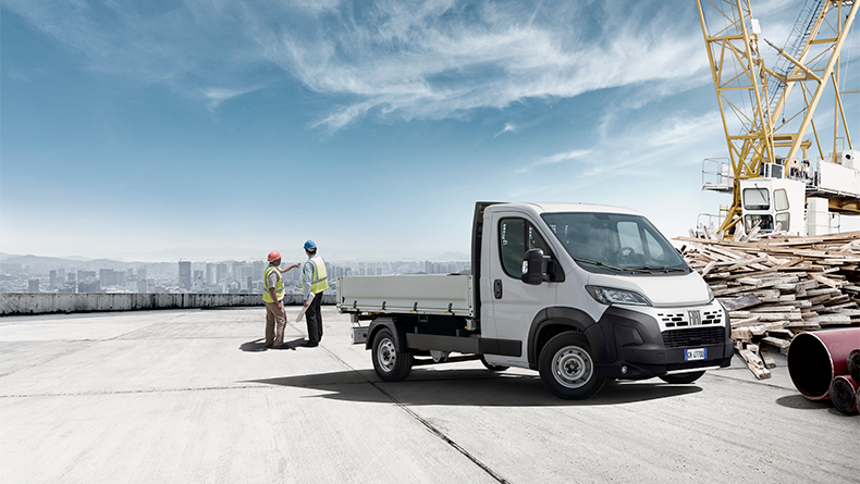 Fiat commercial vehicle parked next to charging station